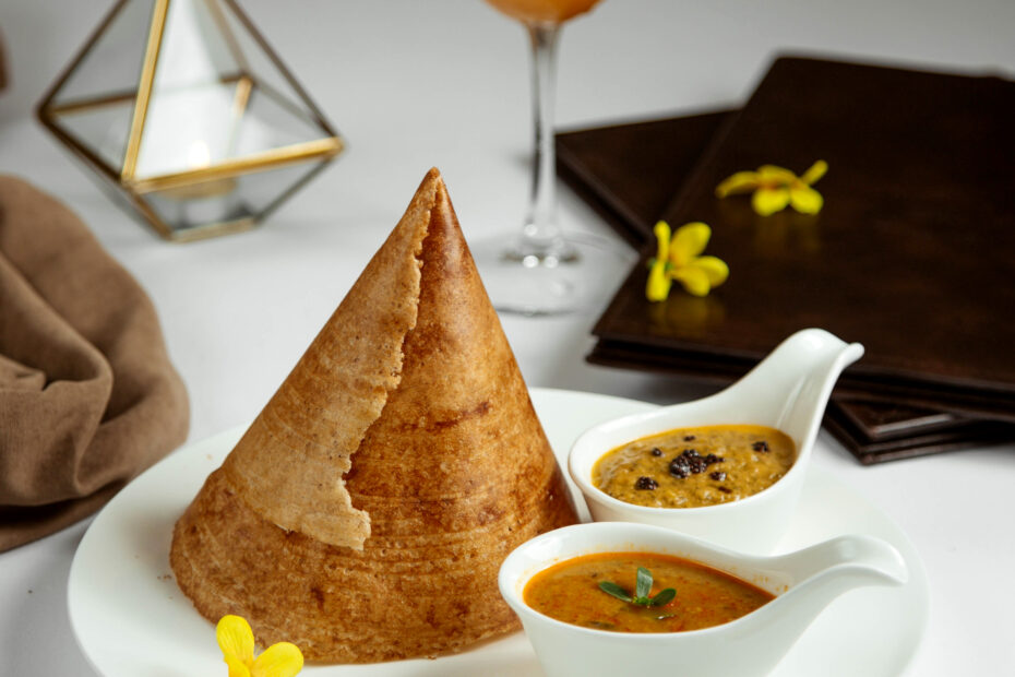 Cone-shaped Rajamudi rice dosa served with sambar and chutney – a Karnataka special dosa made from red rice